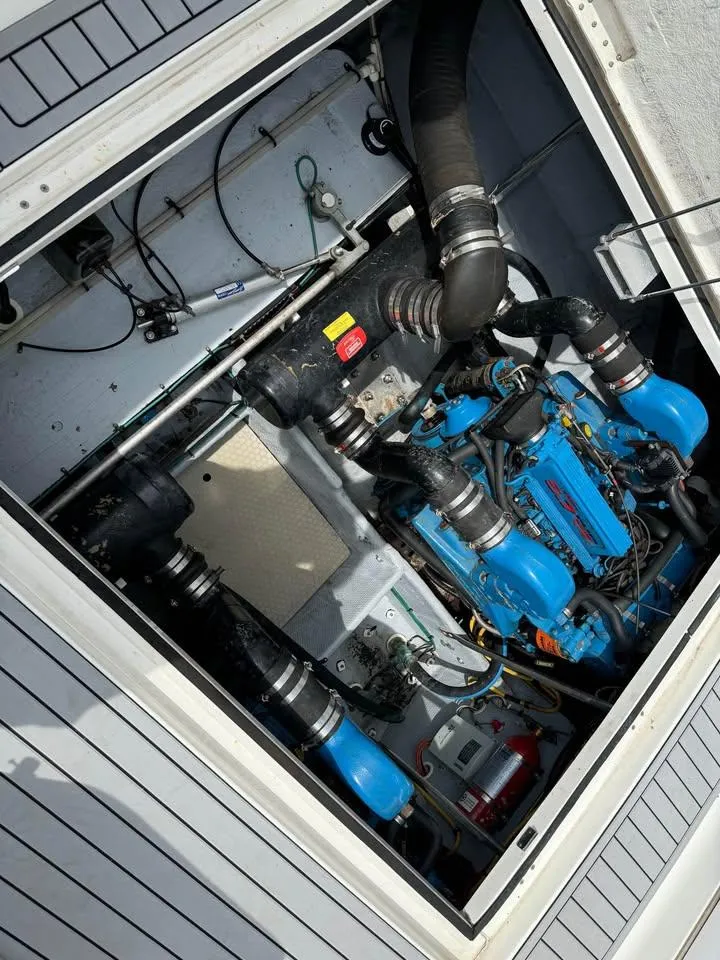 Slide: The Image of Engine compartment of a 2001 Silverton 351 Sedan Cruiser, showcasing blue engine components. - 20