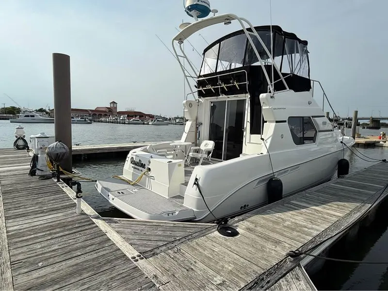 Slide: The Image of 2001 Silverton 351 Sedan Cruiser docked at marina, rear view. - 3