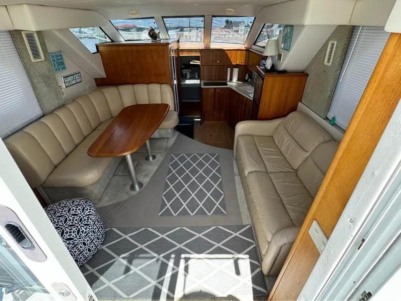 Slide: The Image of Interior of 2001 Silverton 351 Sedan Cruiser with beige seating and wooden accents. - 7