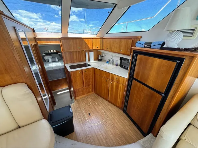 Slide: The Image of 2001 Silverton 351 Sedan Cruiser interior with wood cabinetry and modern amenities. - 8