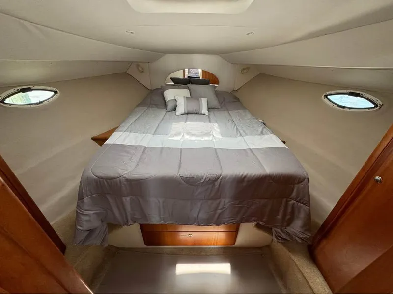Slide: The Image of Interior cabin of 2001 Silverton 351 Sedan Cruiser with bed and portholes. - 9