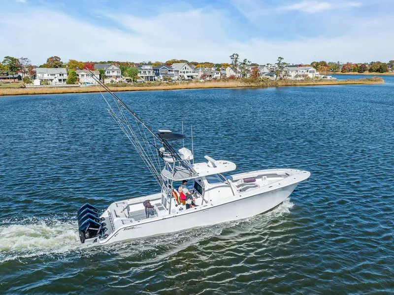 Slide: The Image of 2023 Front Runner 39 Center Console boat cruising on a scenic waterway. - 14