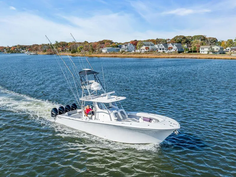 Slide: The Image of 2023 Front Runner 39 Center Console boat cruising on a scenic waterway. - 15