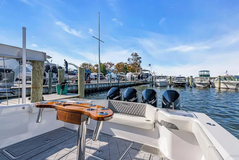Slide: The Image of 2023 Front Runner 39 Center Console boat docked at marina with multiple outboard engines. - 19