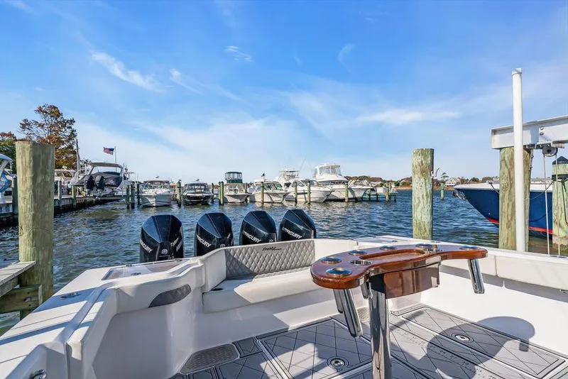 Slide: The Image of 2023 Front Runner 39 Center Console boat docked with multiple outboard engines. - 21