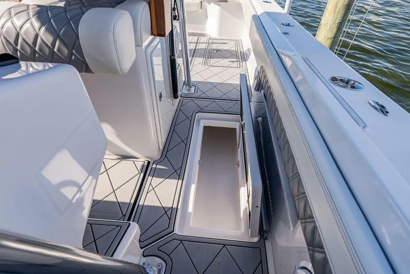 Slide: The Image of 2023 Front Runner 39 Center Console interior with open storage compartment and quilted seating. - 28