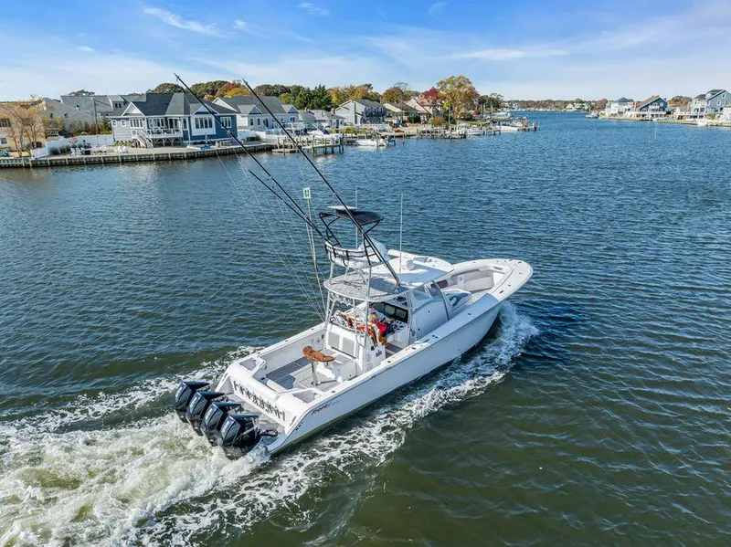 Slide: The Image of 2023 Front Runner 39 Center Console boat cruising on a scenic waterway. - 3
