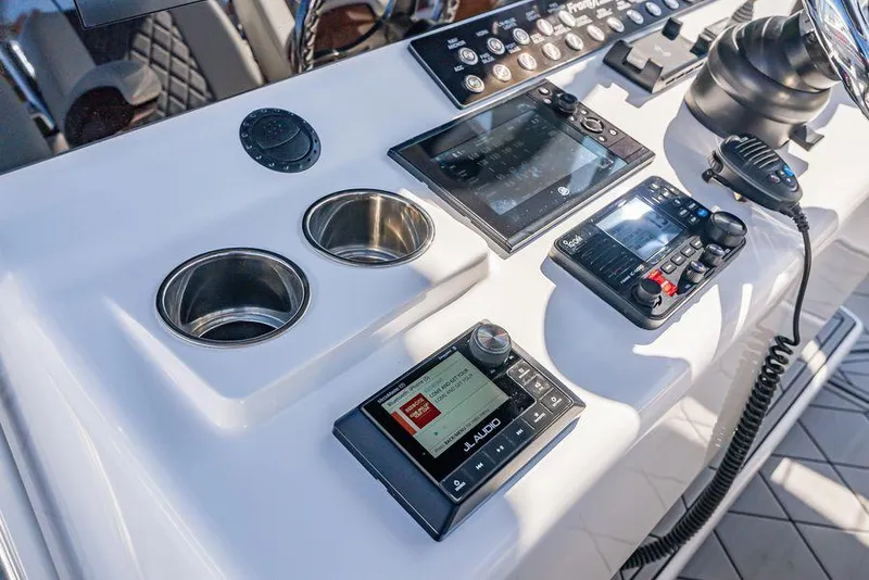 Slide: The Image of 2023 Front Runner 39 Center Console dashboard with controls, displays, and cup holders. - 36