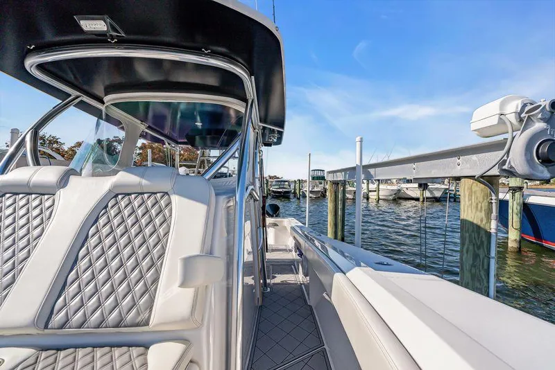 Slide: The Image of 2023 Front Runner 39 Center Console boat docked, featuring sleek design and luxurious seating. - 39