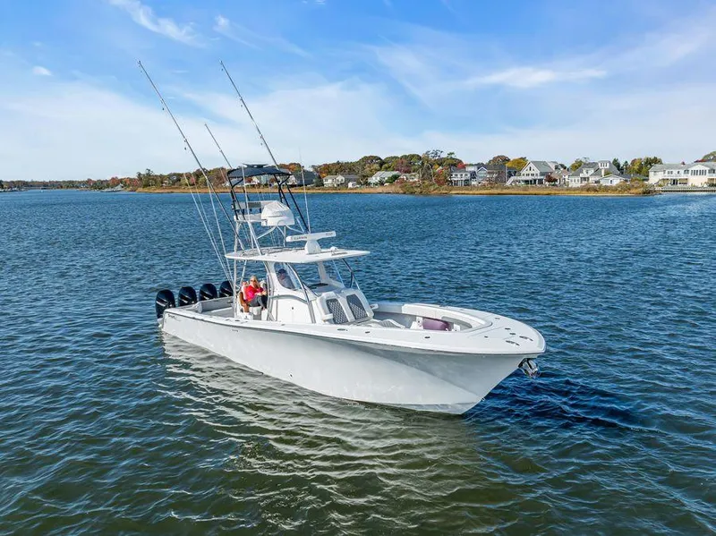 Slide: The Image of 2023 Front Runner 39 Center Console boat cruising on a scenic lake. - 4