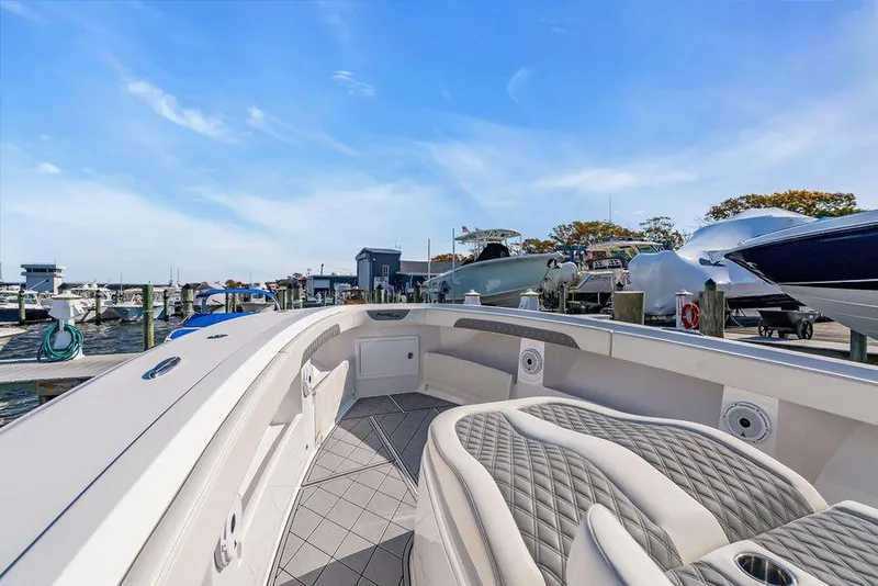 Slide: The Image of 2023 Front Runner 39 Center Console boat docked at marina under clear blue sky. - 40