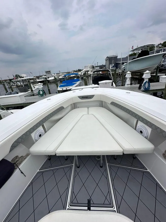 Slide: The Image of 2023 Front Runner 39 Center Console boat docked at marina, featuring spacious seating area. - 41