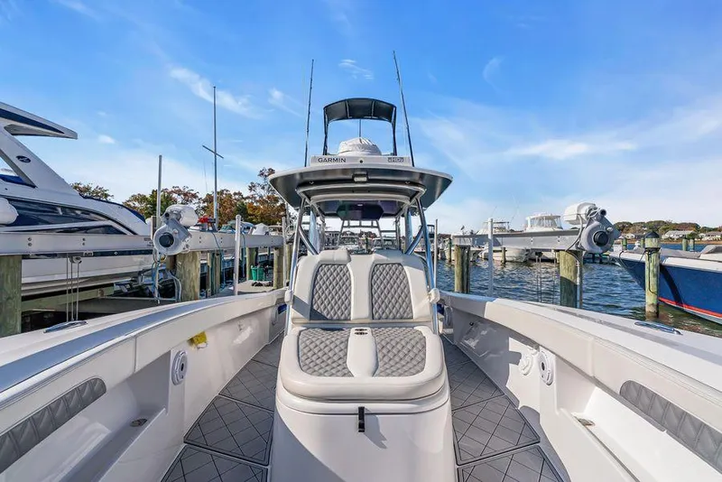 Slide: The Image of 2023 Front Runner 39 Center Console boat docked at marina, clear sky background. - 42