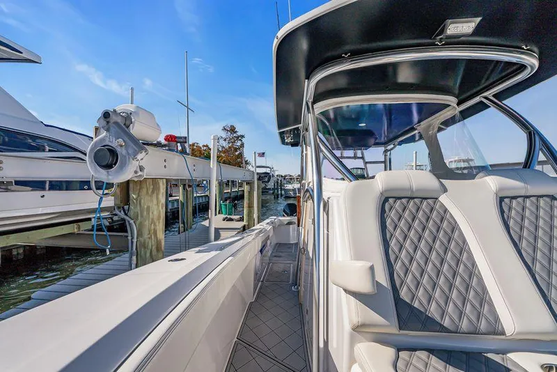 Slide: The Image of 2023 Front Runner 39 Center Console boat docked, featuring sleek design and comfortable seating. - 43