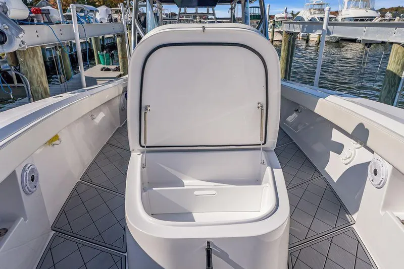Slide: The Image of 2023 Front Runner 39 Center Console boat with open storage compartment at dock. - 45