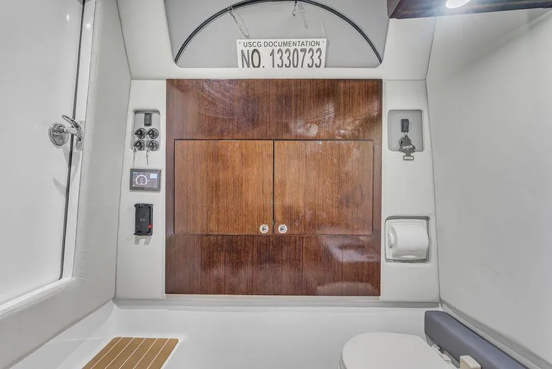 Slide: The Image of 2023 Front Runner 39 Center Console interior with wooden cabinetry and USCG documentation number. - 47