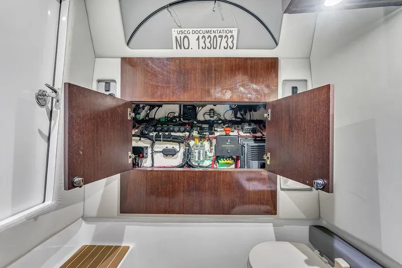 Slide: The Image of 2023 Front Runner 39 Center Console interior with open cabinet revealing electrical components. - 48