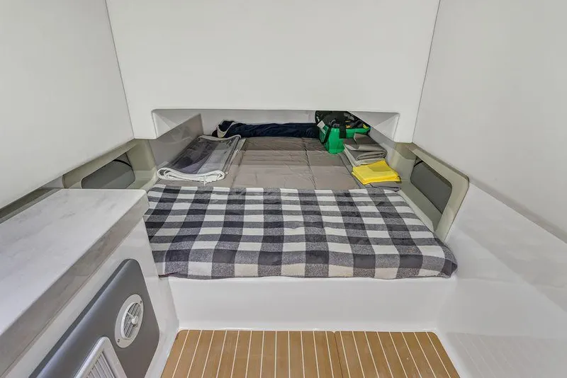 Slide: The Image of 2023 Front Runner 39 Center Console cabin interior with bed and storage space. - 49