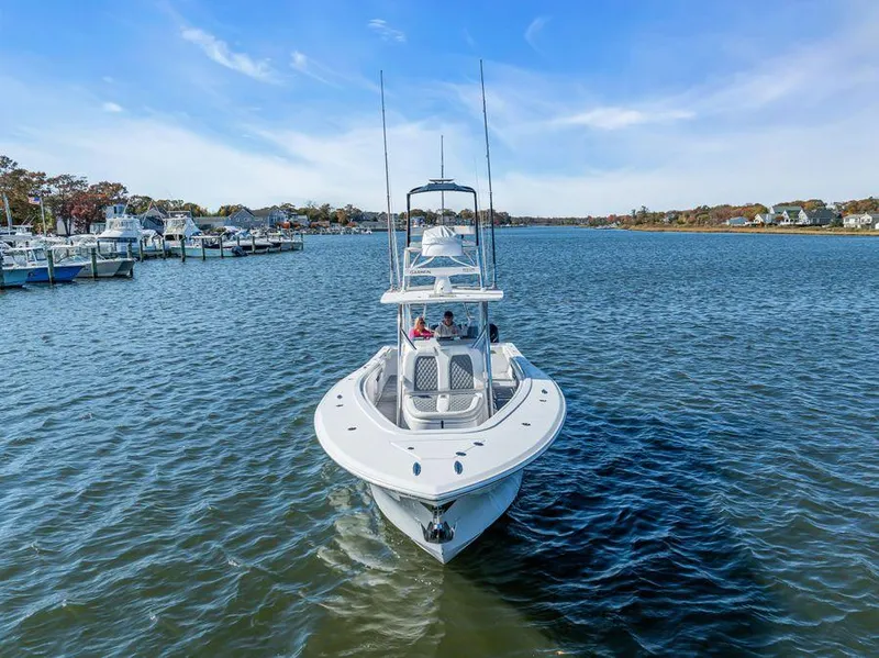 Slide: The Image of 2023 Front Runner 39 Center Console boat cruising on a scenic waterway. - 5