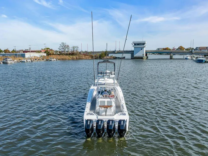 Slide: The Image of 2023 Front Runner 39 Center Console boat with four engines on a calm river. - 6