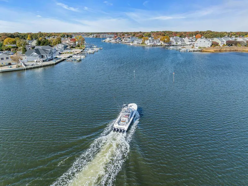 Slide: The Image of Aerial view of 2023 Front Runner 39 Center Console boat cruising through a scenic waterway. - 7