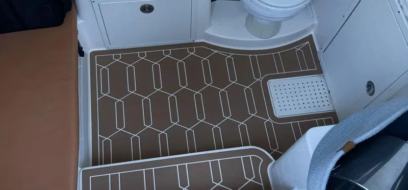 Slide: The Image of 2018 Cobia 344 Center Console interior with patterned flooring and seating area. - 11