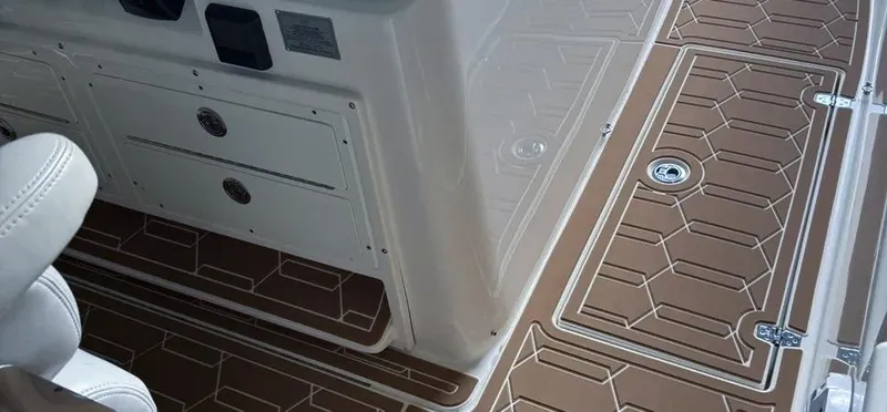 Slide: The Image of 2018 Cobia 344 Center Console boat interior with brown and white deck design. - 8