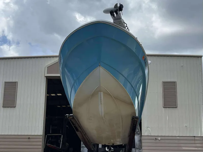 Slide: The Image of 2007 Andros Tarpon 26 boat in front of a warehouse, viewed from below. - 10
