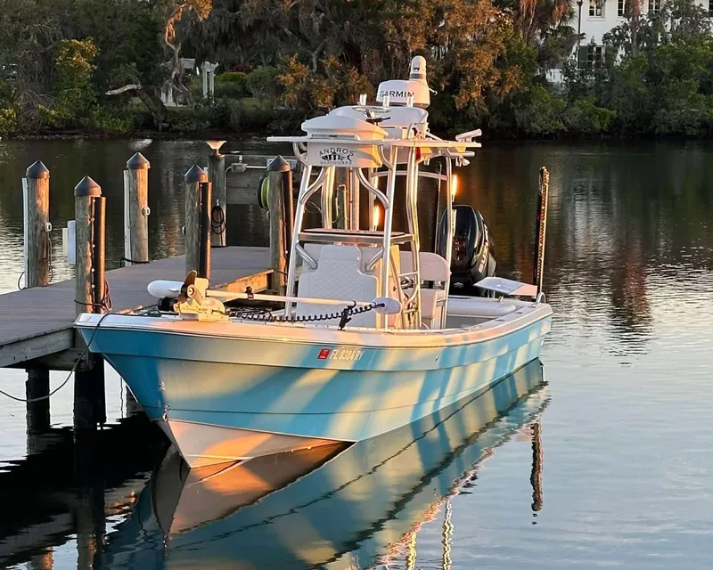 Slide: The Image of 2007 Andros Tarpon 26 boat docked on calm water at sunset. - 2