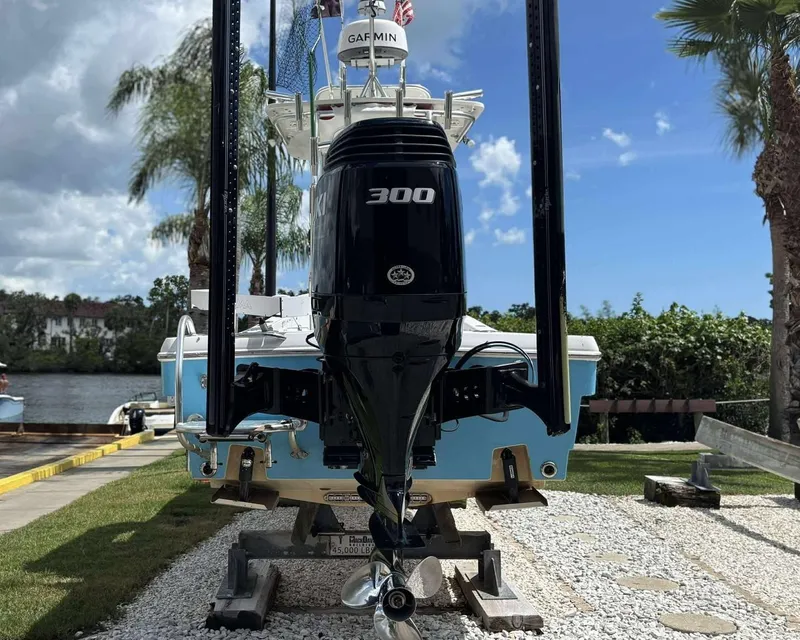 Slide: The Image of 2007 Andros Tarpon 26 boat with Suzuki 300 outboard motor, docked near a scenic waterfront. - 26