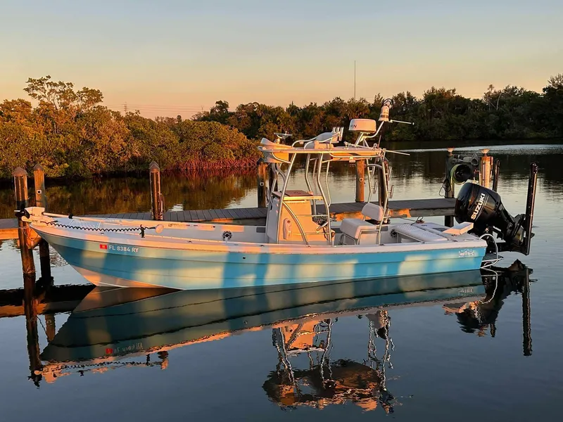 Slide: The Image of 2007 Andros Tarpon 26 boat docked on calm water at sunset. - 3
