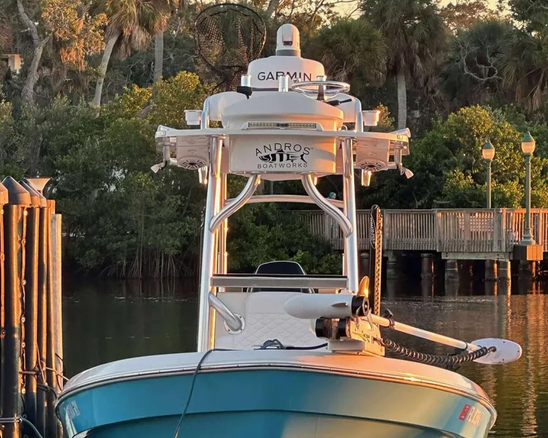 Slide: The Image of 2007 Andros Tarpon 26 boat docked near lush greenery and wooden pier. - 6