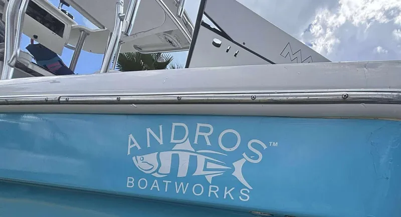 Slide: The Image of 2007 Andros Tarpon 26 boat with logo, blue hull, and stainless steel railing. - 8