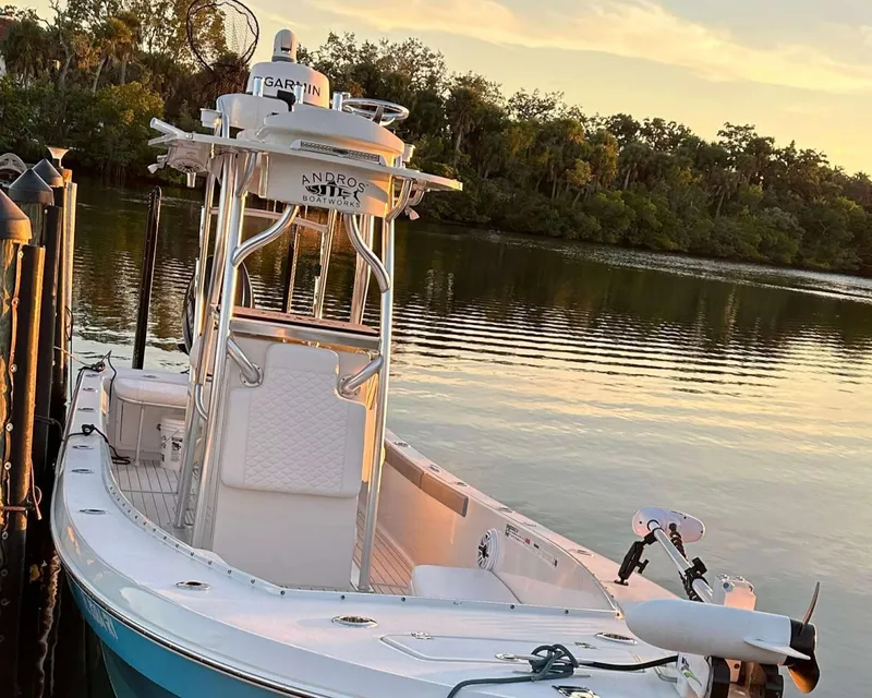 Slide: The Image of 2007 Andros Tarpon 26 boat docked by a serene lake at sunset. - 11