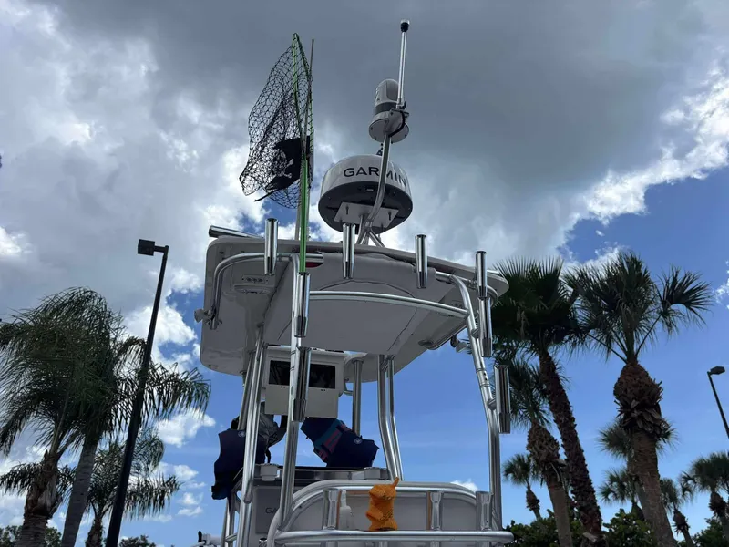 Slide: The Image of 2007 Andros Tarpon 26 boat tower with radar, under cloudy sky and palm trees. - 25