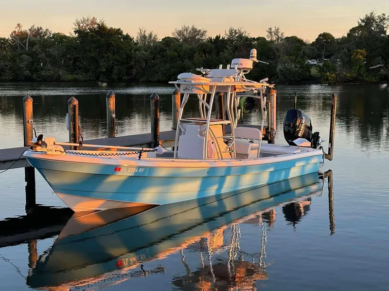 Slide: The Image of 2007 Andros Tarpon 26 boat docked on calm water at sunset. - 7