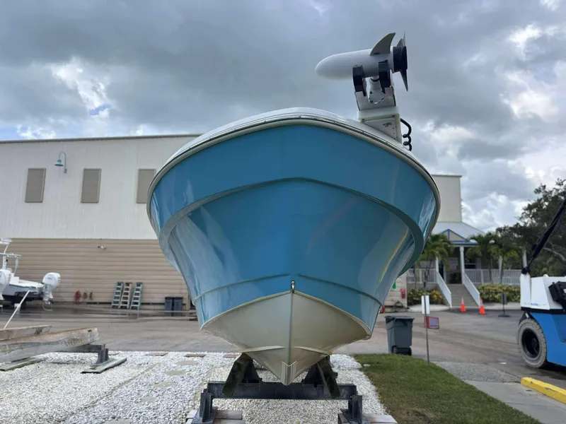 Slide: The Image of 2007 Andros Tarpon 26 boat on trailer, blue hull, cloudy sky background. - 9