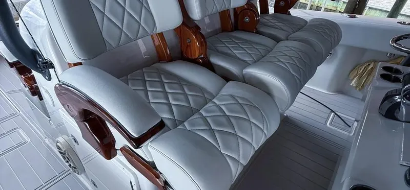 Slide: The Image of Luxurious seating on a 2019 Freeman 42 LR boat with quilted leather and wooden accents. - 14