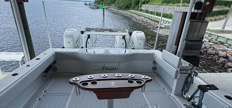 Slide: The Image of 2019 Freeman 42 LR boat interior with fishing rod holders, docked by a calm waterfront. - 15