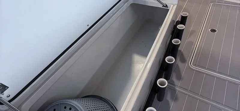 Slide: The Image of Open storage compartment on 2019 Freeman 42 LR boat with rod holders. - 22