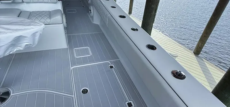 Slide: The Image of 2019 Freeman 42 LR boat interior with sleek gray flooring and seating by the water. - 28