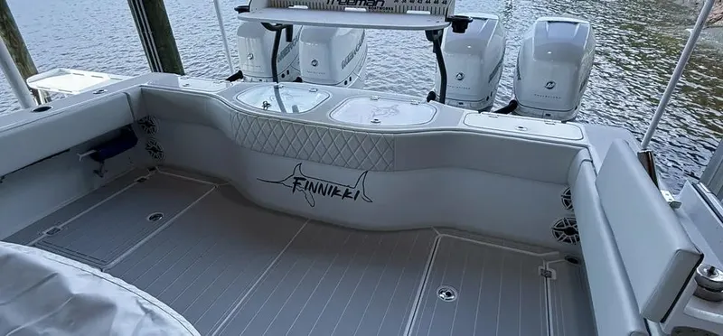 Slide: The Image of Freeman 42 LR 2019 boat deck with seating and outboard motors by the water. - 29