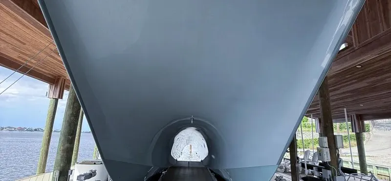 Slide: The Image of 2019 Freeman 42 LR boat hull in a dockside setting. - 3