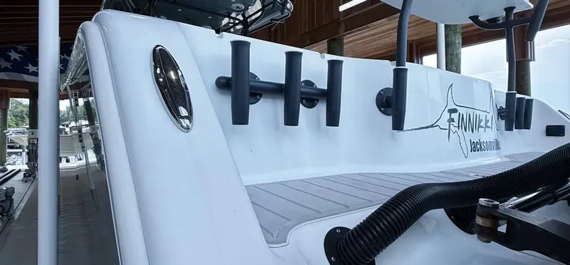 Slide: The Image of 2019 Freeman 42 LR boat docked, featuring rod holders and sleek design. - 30