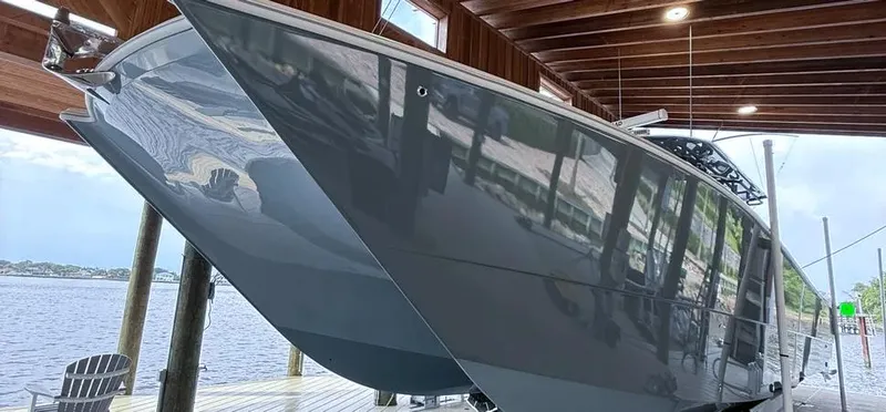 Slide: The Image of 2019 Freeman 42 LR boat docked under wooden shelter by the water. - 4