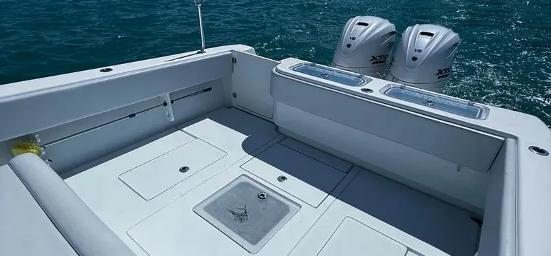 Slide: The Image of 2022 Contender 39 ST boat deck with twin outboard engines on the ocean. - 13