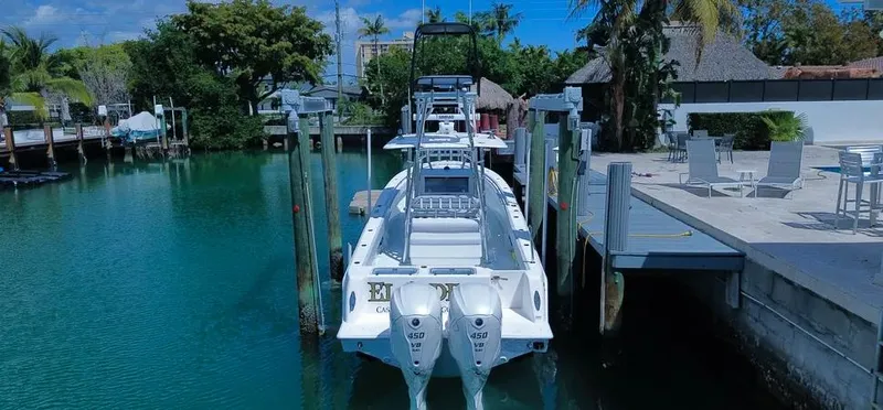 Slide: The Image of 2022 Contender 39 ST boat docked in a scenic marina setting. - 19