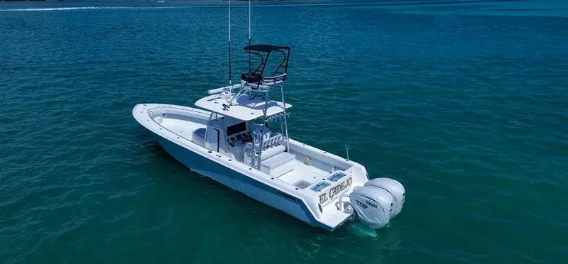 Slide: The Image of 2022 Contender 39 ST boat on clear blue water, featuring dual outboard engines. - 2