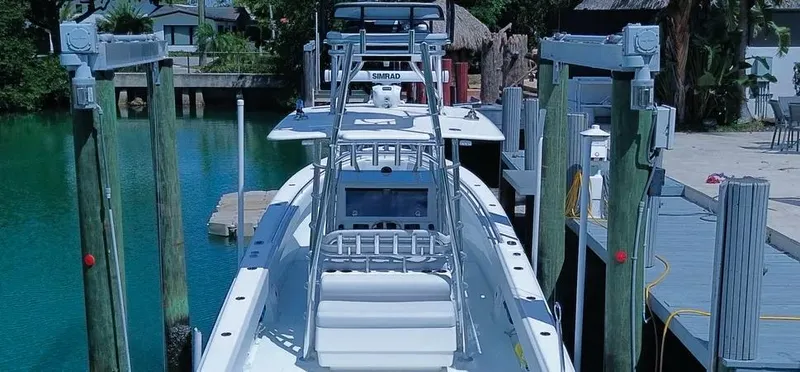 Slide: The Image of 2022 Contender 39 ST boat docked, featuring advanced navigation equipment and sleek design. - 20