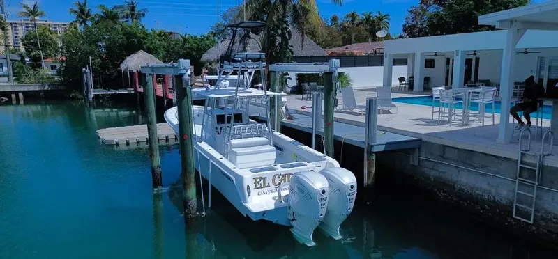 Slide: The Image of 2022 Contender 39 ST boat docked by a waterfront property with a pool. - 21